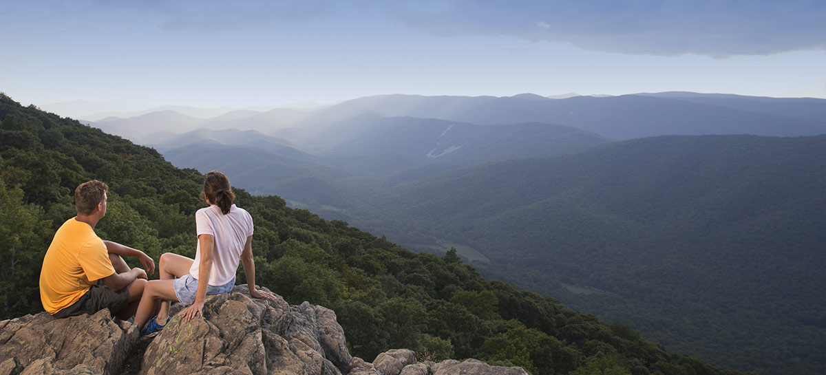 couple hiking and enjoying mountain views
